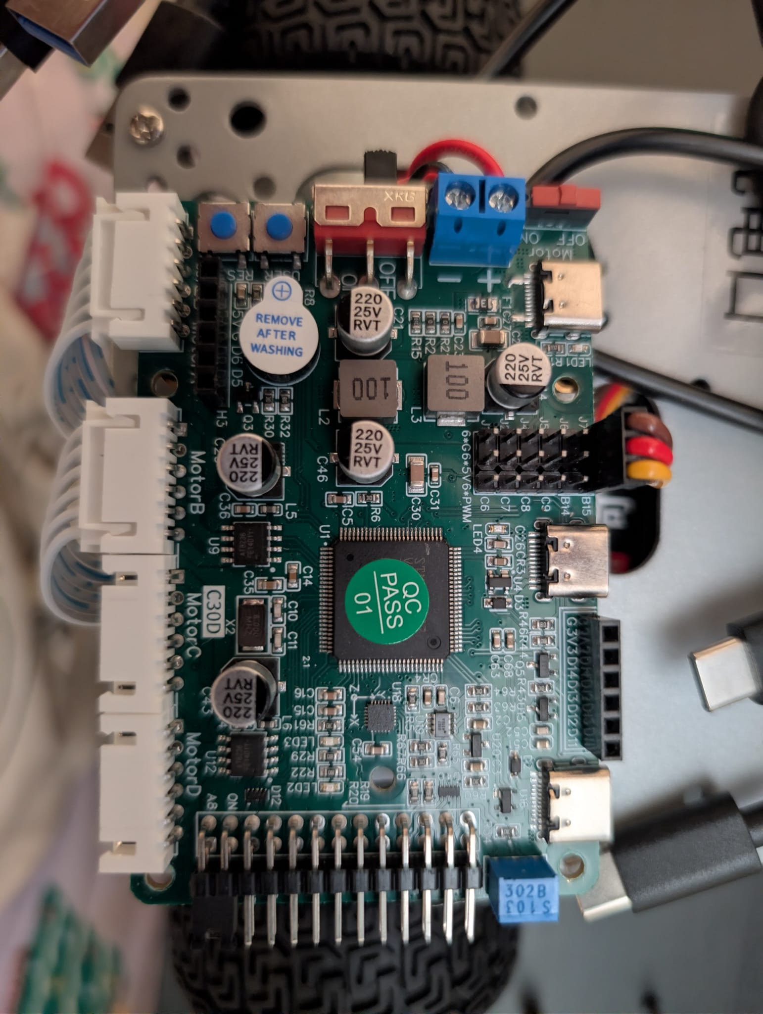 Close-up of the C30D motor, steering, encoder, and IMU controller mounted below the compute stack